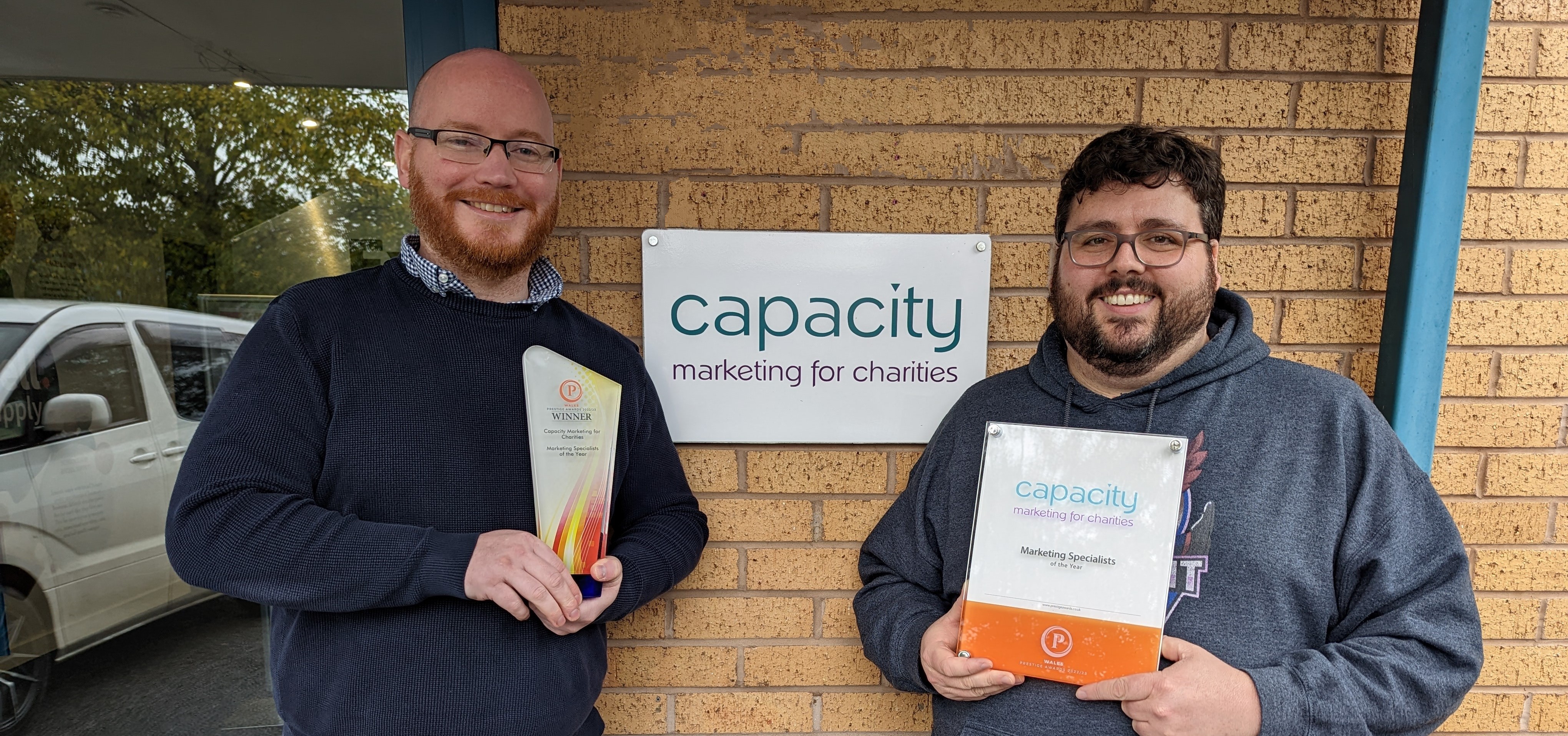Jon Allport (Operations Director) and Richard Millar (Managing Director) with the Prestige Award outside Capacity's office