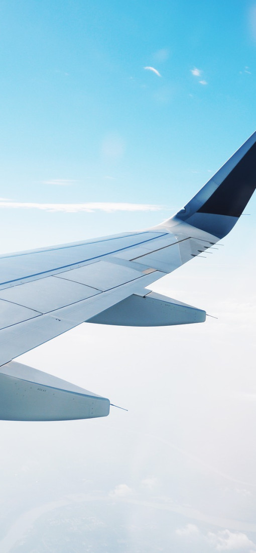 A photo of the wing of a plane in mid-flight
